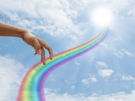 Hand walking on rainbow wayの写真素材
