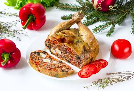 chicken in a section stuffed with vegetables and mushrooms on a white backgroundの写真素材