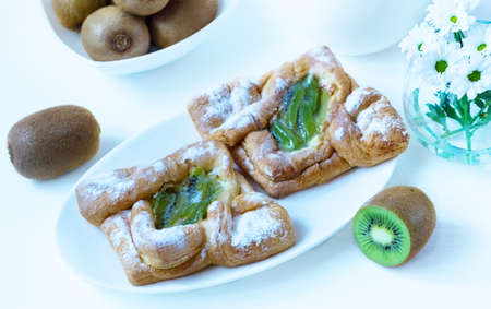 pastries from a kiwi on a white plate on a white backgroundの写真素材