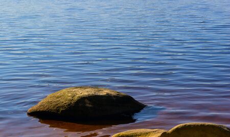 stone at the coast against waterの写真素材