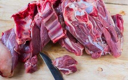 crude meat on a wooden backgroundの写真素材