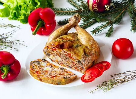chicken in a section stuffed with vegetables and mushrooms on a white backgroundの写真素材