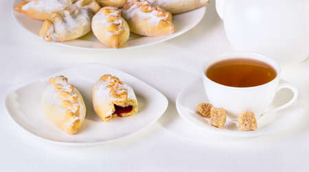 small pies on a white plate on a white wooden backgroundの写真素材