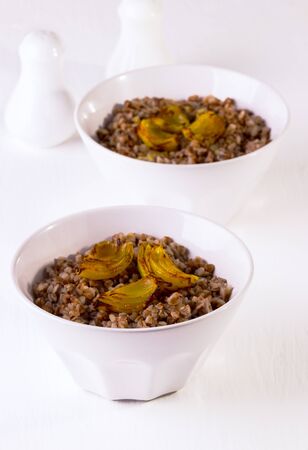 buckwheat cereal with onions on a white backgroundの写真素材