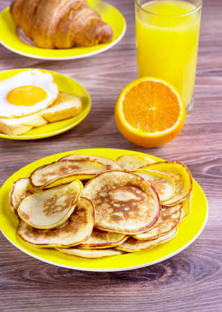 pancakes, juice, egg, croissant for breakfastの写真素材
