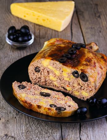 chicken stuffed with cheese and olives on a wooden backgroundの写真素材