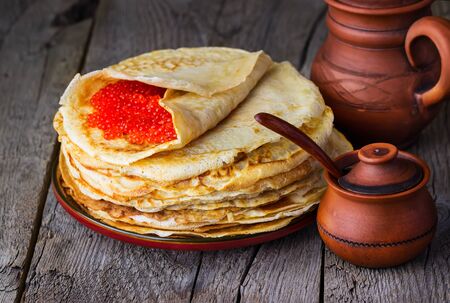 pancakes with red caviar on a wooden backgroundの写真素材