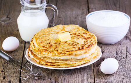 pancakes with oil on a wooden backgroundの写真素材