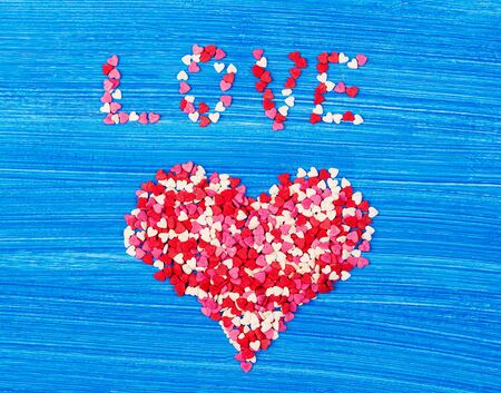heart from a confectionery decor on a blue wooden backgroundの写真素材