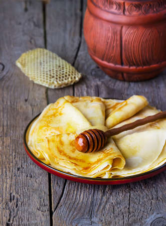 pancakes with honey on a wooden backgroundの写真素材
