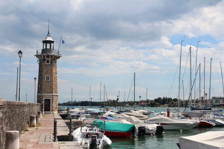 August 1, 2016, lighthouse on Garda Lake (Lago di Garda), Northern Italy. View from city of Desenzano del Garda on sunny summer day. Natural background. Landscape. Desenzano del Garda port.のeditorial素材