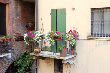 August 2, 2016, Mantua, Lombardy, Italy. House with floral balcony, typical italian view. Popular touristic european destination. Mantua city viewのeditorial素材