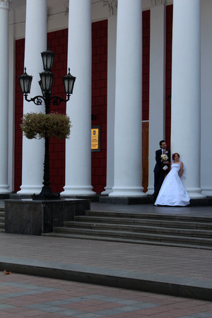 September 10, 2014, just married couple in front of City Hall of Odessa, Ukraine. Popular touristic european destination.のeditorial素材