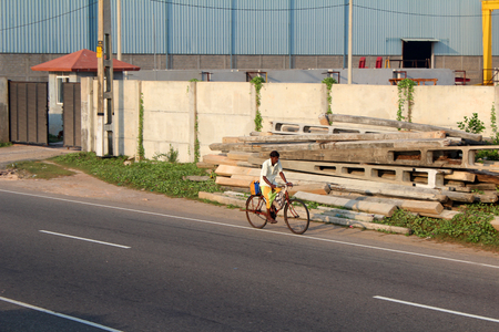 January 5, 2018, Hikkaduwa, Sri lanka. Hikkaduwa street with  a man on bicycle, typical sri lankan street view. Popular touristic asian destination. Hikkaduwa city viewのeditorial素材