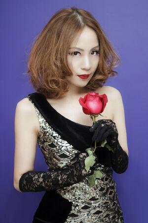 The sexy Asian woman holding red rose in her handの写真素材
