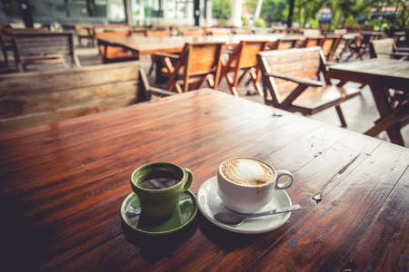 A cup of coffee on the wooden deskの写真素材
