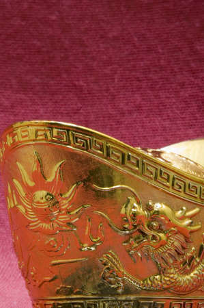 Chinese gold ingot engraved with dragon designの写真素材