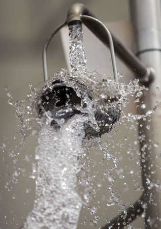 Bucket releasing water at theme parkの写真素材