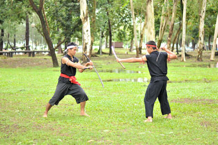 PUKED,THAILAND - AUGUST 28: Master trick of ancient fighter on August 28, 2011 in Puked Thailand.  Master show how to trick of fight with swords.のeditorial素材
