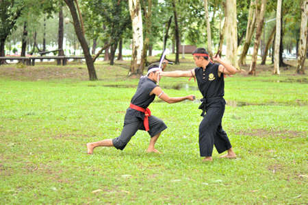 PUKED,THAILAND - AUGUST 28: Master trick of ancient fighter on August 28, 2011 in Puked Thailand.  Master show how to trick of fight with swords.のeditorial素材