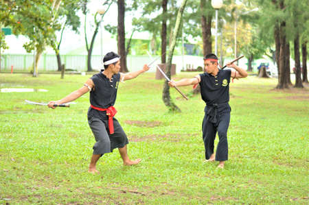 PUKED,THAILAND - AUGUST 28: Master trick of ancient fighter on August 28, 2011 in Puked Thailand.  Master show how to trick of fight with swords.のeditorial素材