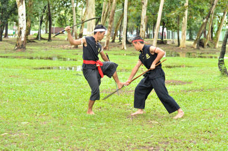 PUKED,THAILAND - AUGUST 28: Master trick of ancient fighter on August 28, 2011 in Puked Thailand.  Master show how to trick of fight with swords.のeditorial素材