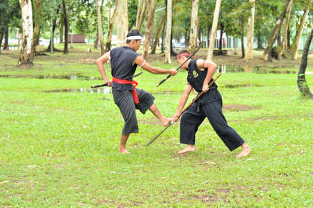 PUKED,THAILAND - AUGUST 28: Master trick of ancient fighter on August 28, 2011 in Puked Thailand.  Master show how to trick of fight with swords.のeditorial素材