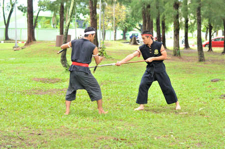 PUKED,THAILAND - AUGUST 28: Master trick of ancient fighter on August 28, 2011 in Puked Thailand.  Master show how to trick of fight with swords.のeditorial素材