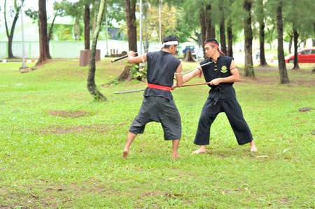 PUKED,THAILAND - AUGUST 28: Master trick of ancient fighter on August 28, 2011 in Puked Thailand.  Master show how to trick of fight with swords.のeditorial素材