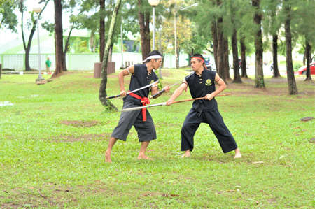 PUKED,THAILAND - AUGUST 28: Master trick of ancient fighter on August 28, 2011 in Puked Thailand.  Master show how to trick of fight with swords.のeditorial素材