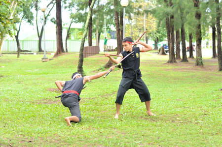 PUKED,THAILAND - AUGUST 28: Master trick of ancient fighter on August 28, 2011 in Puked Thailand.  Master show how to trick of fight with swords.のeditorial素材
