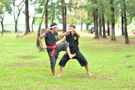 PUKED,THAILAND - AUGUST 28: Master trick of ancient fighter on August 28, 2011 in Puked Thailand.  Master show how to trick of fight with swords.のeditorial素材