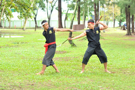 PUKED,THAILAND - AUGUST 28: Master trick of ancient fighter on August 28, 2011 in Puked Thailand.  Master show how to trick of fight with swords.のeditorial素材