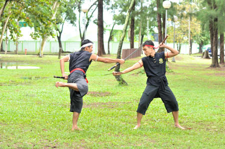 PUKED,THAILAND - AUGUST 28: Master trick of ancient fighter on August 28, 2011 in Puked Thailand.  Master show how to trick of fight with swords.のeditorial素材