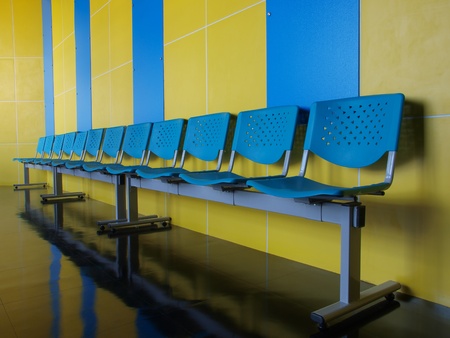 row of empty blue chairs   の写真素材