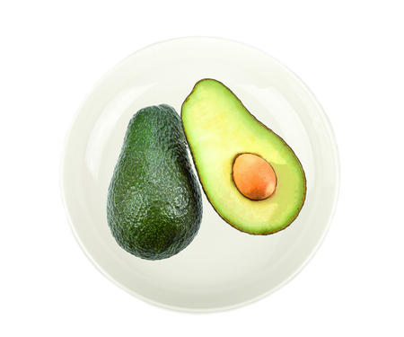 Avocado in white plate on white backgroundの写真素材