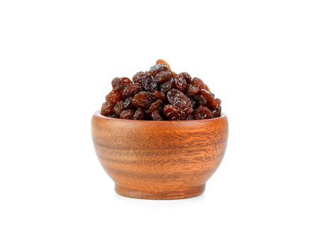Black raisin on wood bowl isolated on white backgroundの写真素材