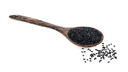 sesame seed in wood spoon isolated on white backgroundの写真素材