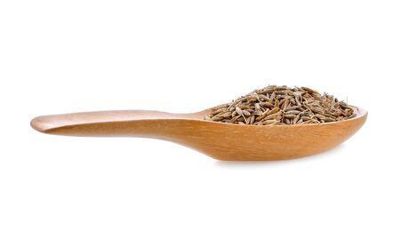 caraway seeds in wood spoon on white backgroundの写真素材