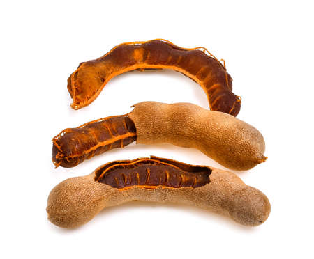fresh tamarind fruits isolated on white backgroundの写真素材