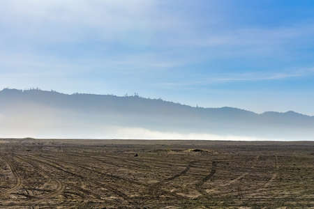 Desert landscape was covered by gas from volcano.の写真素材