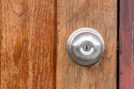 Close up of doorknob with wooden doorの写真素材