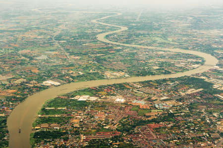 Top view of Chaopraya river and Bangkok city on haze day that capture on airplane.の写真素材