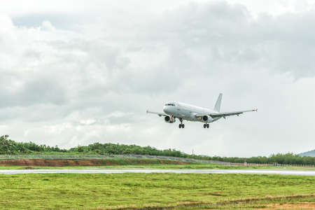 Airplane is landing on the airport before a storm approaching.の写真素材