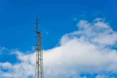 Telecommunication tower on blue sky background.
