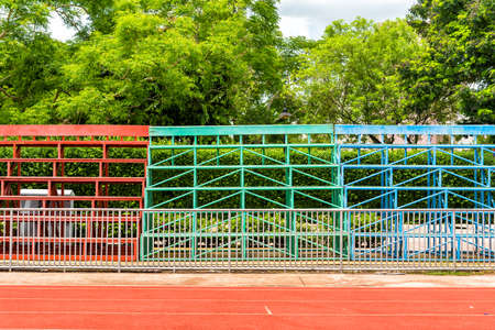 Rows of metal grandstand empty seats of football fieldの写真素材