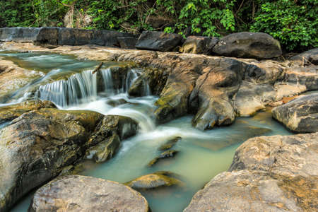 Mountain river with. Waterfall scenery in the middle of green forest.の写真素材