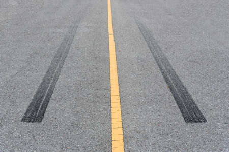Tire tracks , Wheel trace on asphalt road.の写真素材
