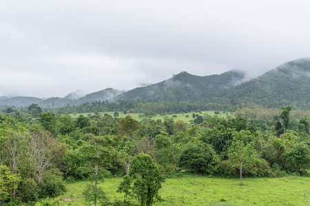 Mountains, forest and clouds in the sky.の写真素材