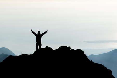Silhouette of man spreading hand on top of mountain, Mount Rinjani, Lombok island, Indonesia.の写真素材